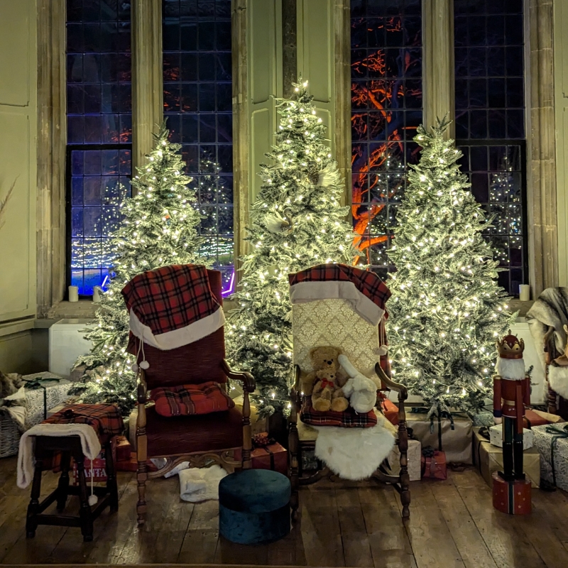 An image of Bishop Wynne Willson's Study, decorated with Christmas trees and Father Christmas' chair