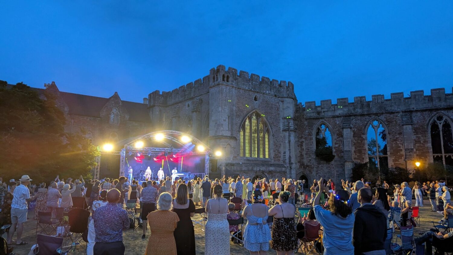 Party at the Palace (credit Adam Saunders) 2 Image of a music event with stage and audience taking place on the lawns in front of a medieval Palace in Somerset