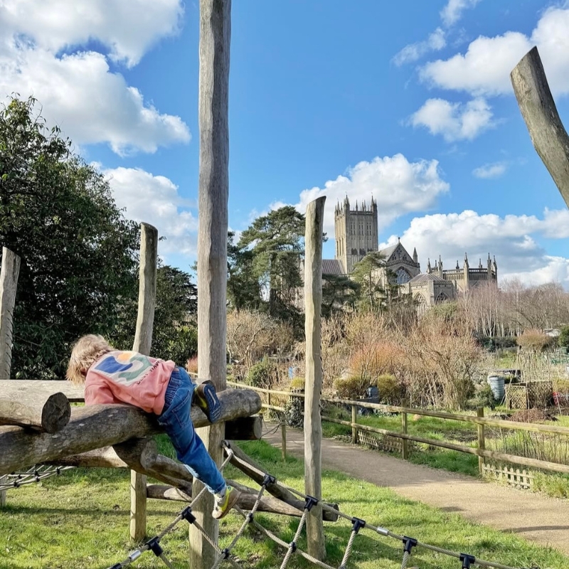 An image of a child playing on the Dragon's Lair play area at The Bishop's Palace.