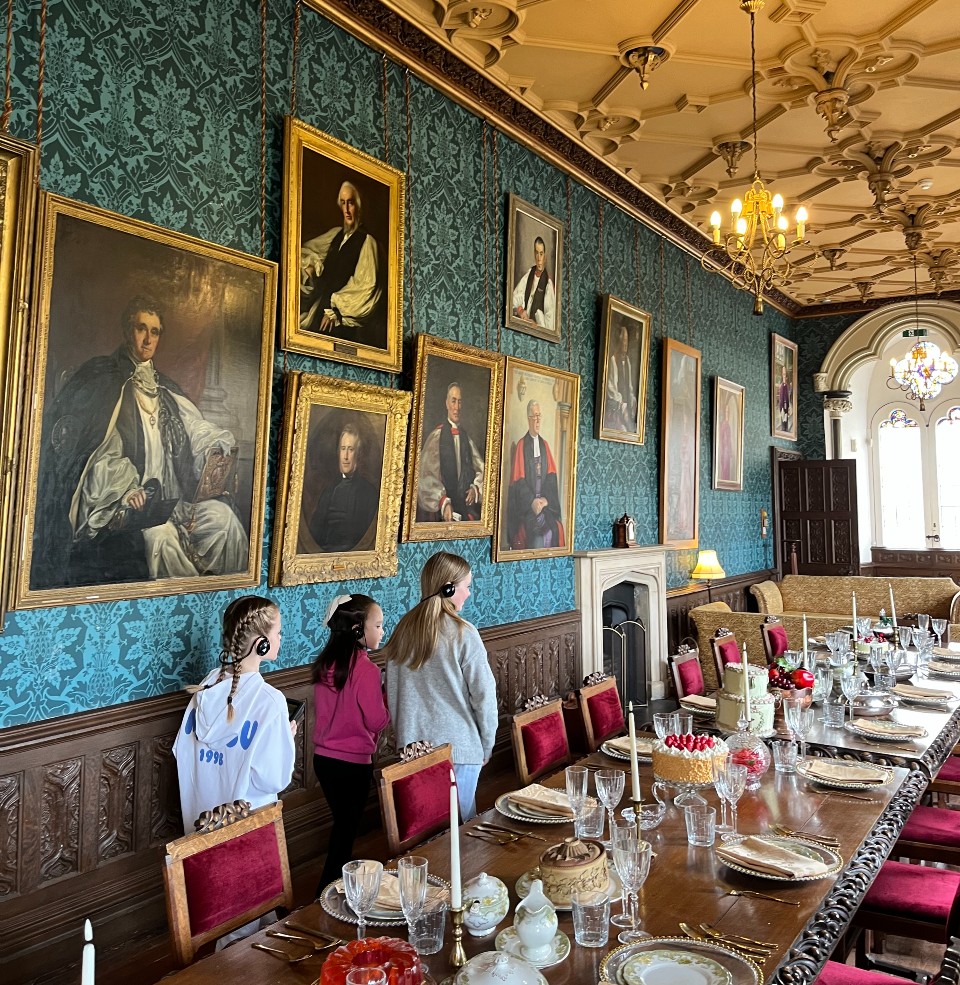 Image of children using audio guides to explore a room in a heritage building