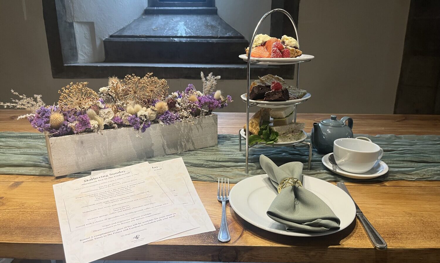 An image of the Mothering Sunday Afternoon Tea served in the historic Undercroft at The Bishop's Palace in Wells, Somerset