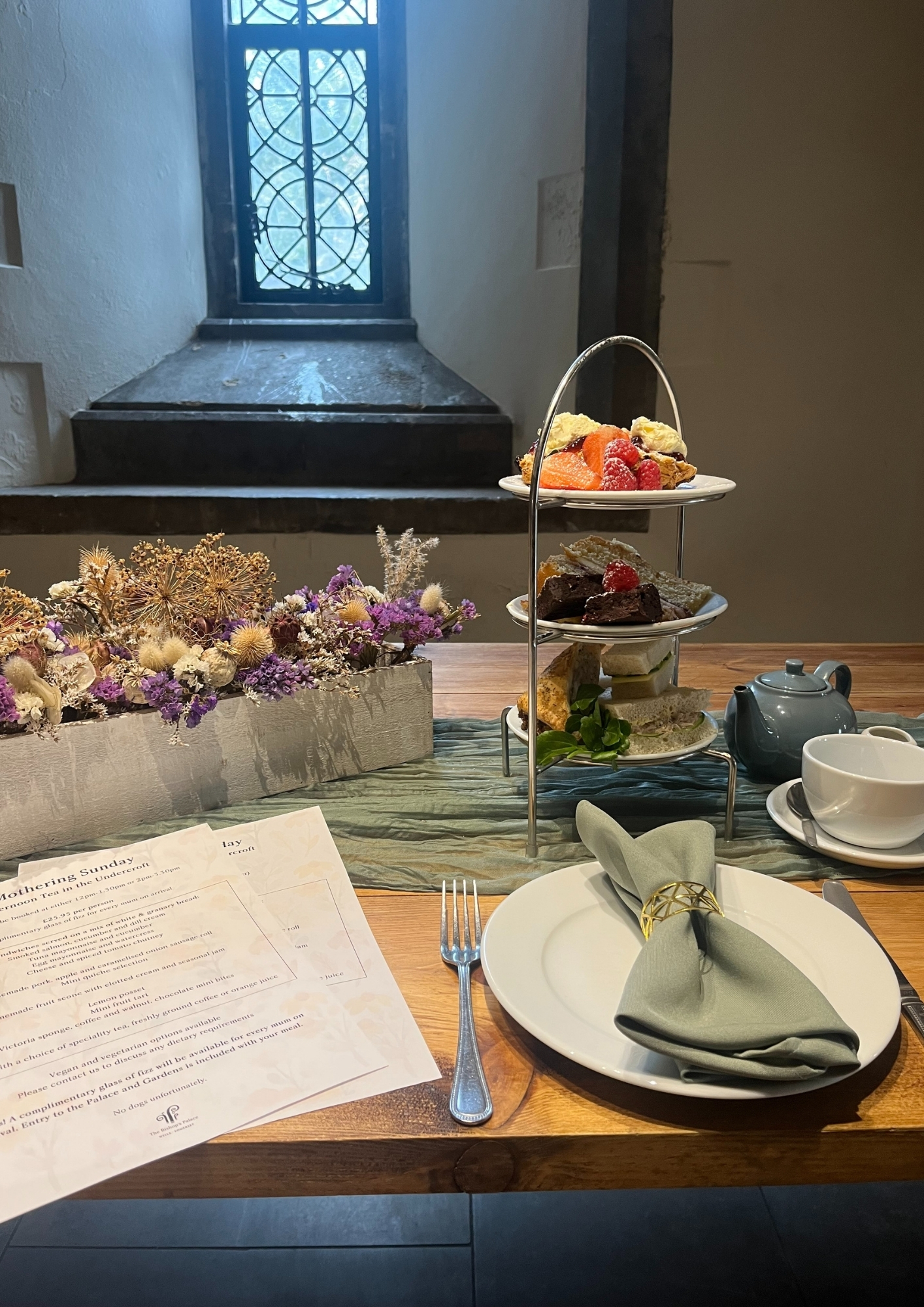 An image of the Mothering Sunday Afternoon Tea, served in the medieval Undercroft at The Bishop's Palace in Wells, Somerset