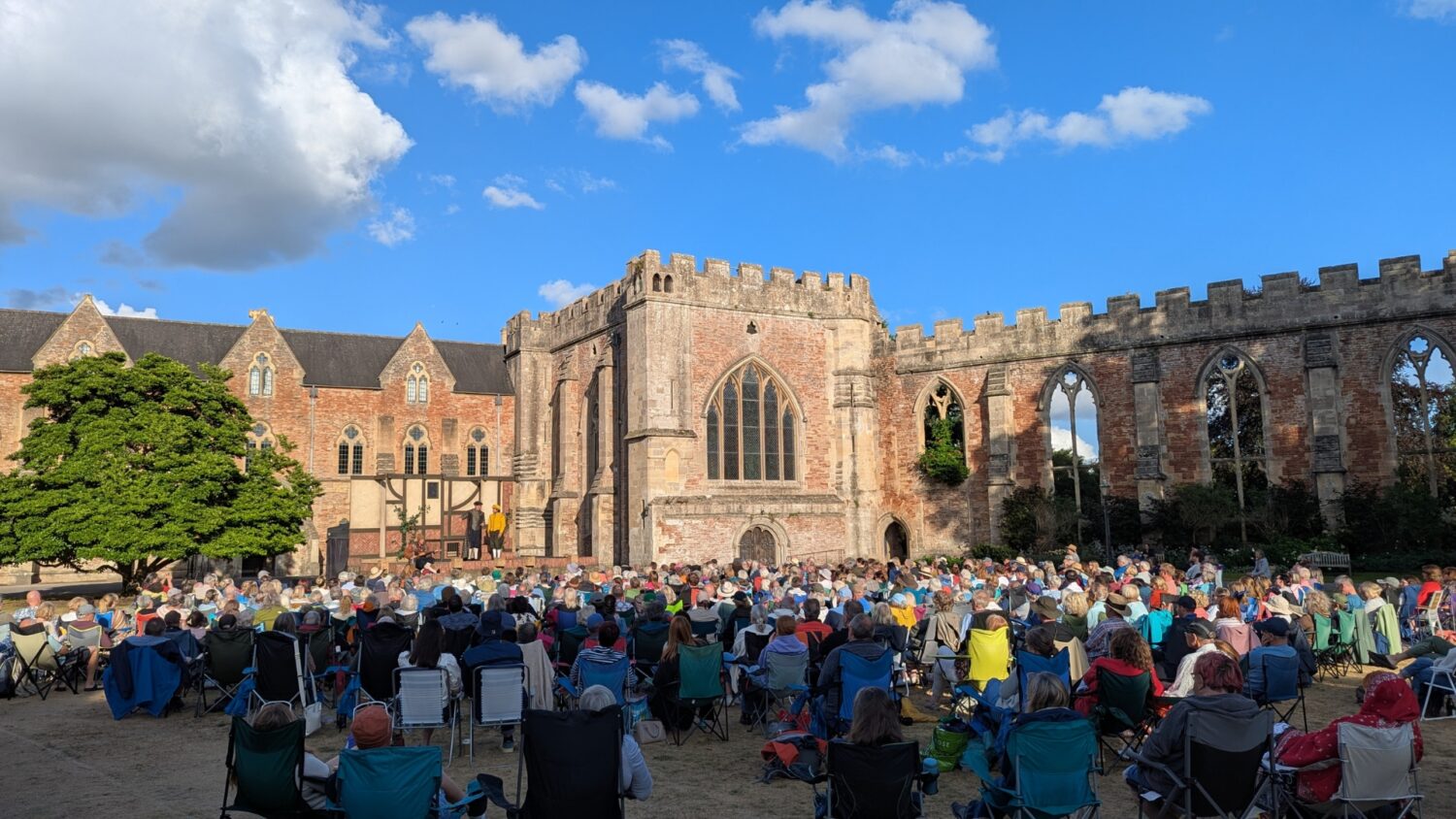 An image of an outdoor theatre performance at The Bishop's Palace in Wells, Somerset.