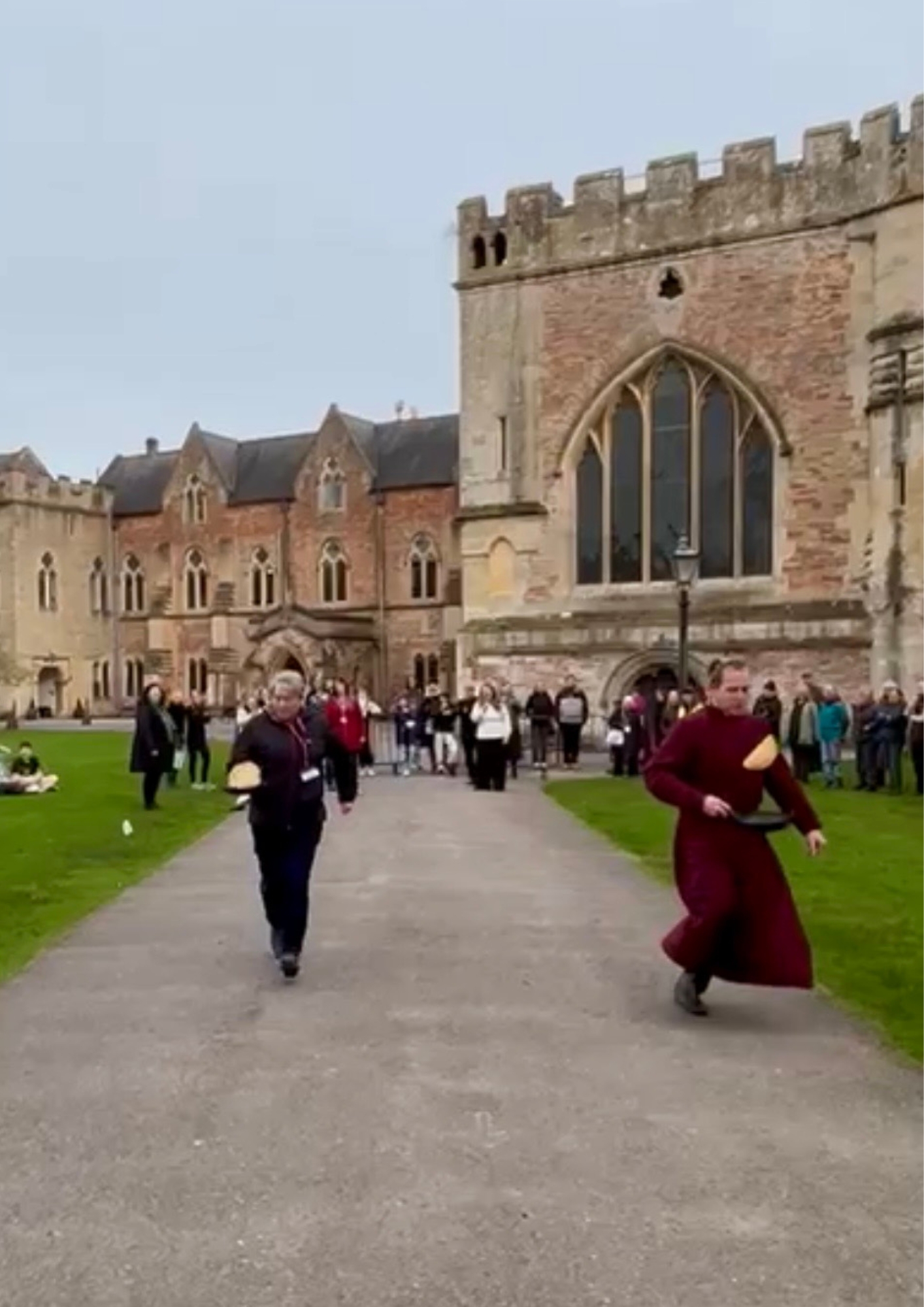 An image of the staff at The Bishop's Palace and Wells Cathedral during the Shrove Tuesday Pancake Race