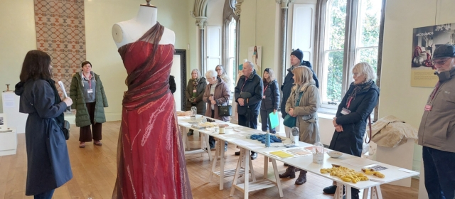An image of volunteers at The Bishop's Palace attending a talk by AO Textiles about a recent exhibition.