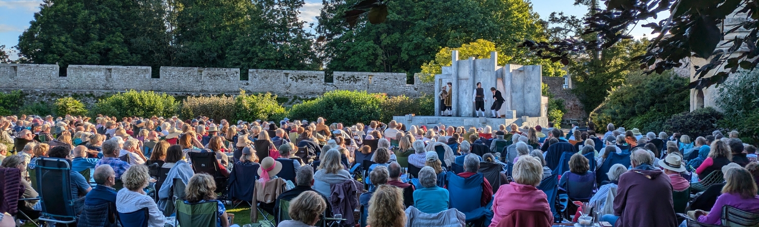 An image of a summer outdoor theatre performance taking place at The Bishop's Palace and Gardens