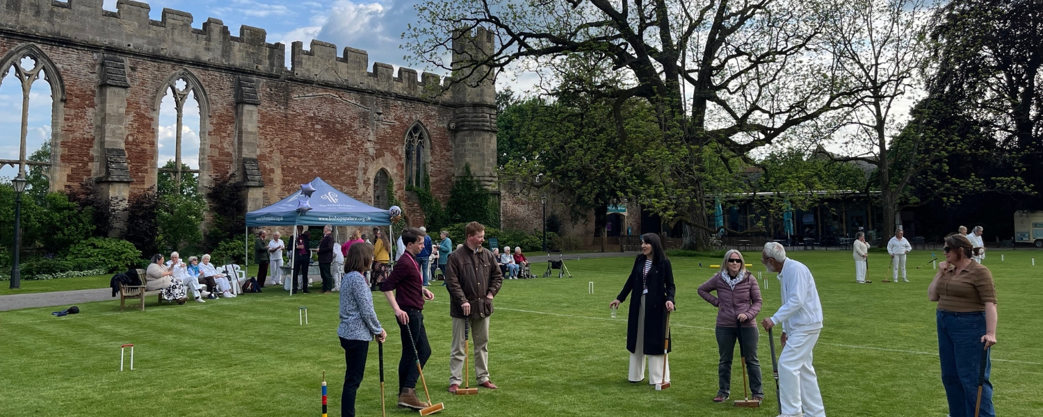 An image of some of the staff at The Bishop's Palace playing croquet in celebration of the Croquet Club's 50th anniversary.
