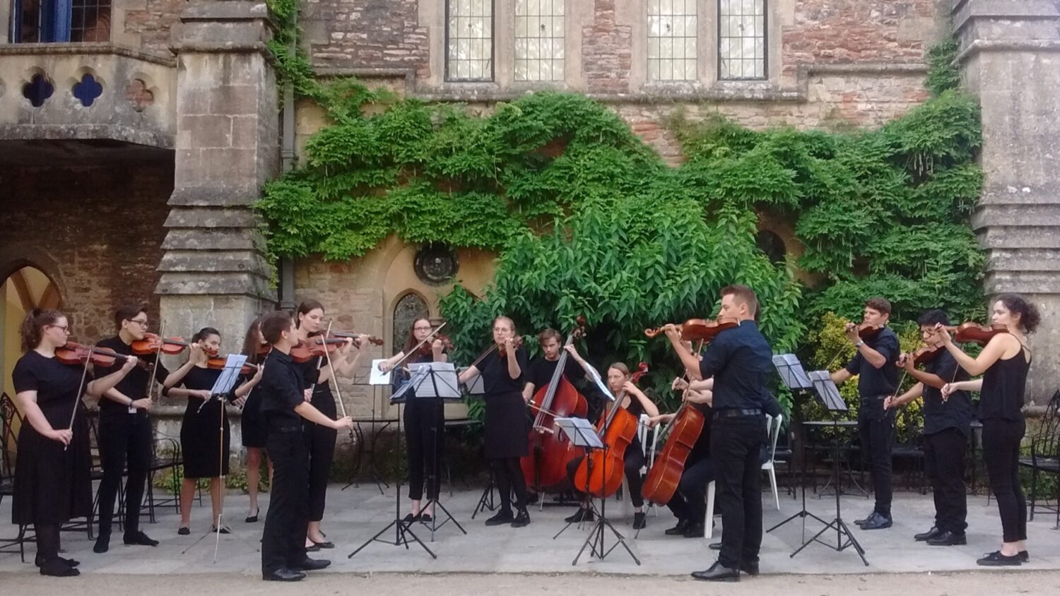 An image of muscisans perfprming at The Bishop's Palace as part of the WOWFest: Wells Orchestral Weekend which will take place on Sunday 12th July.