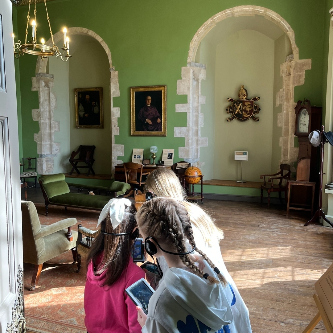 An image of a family enjoying the multimedia tour at The Bishop's Palace