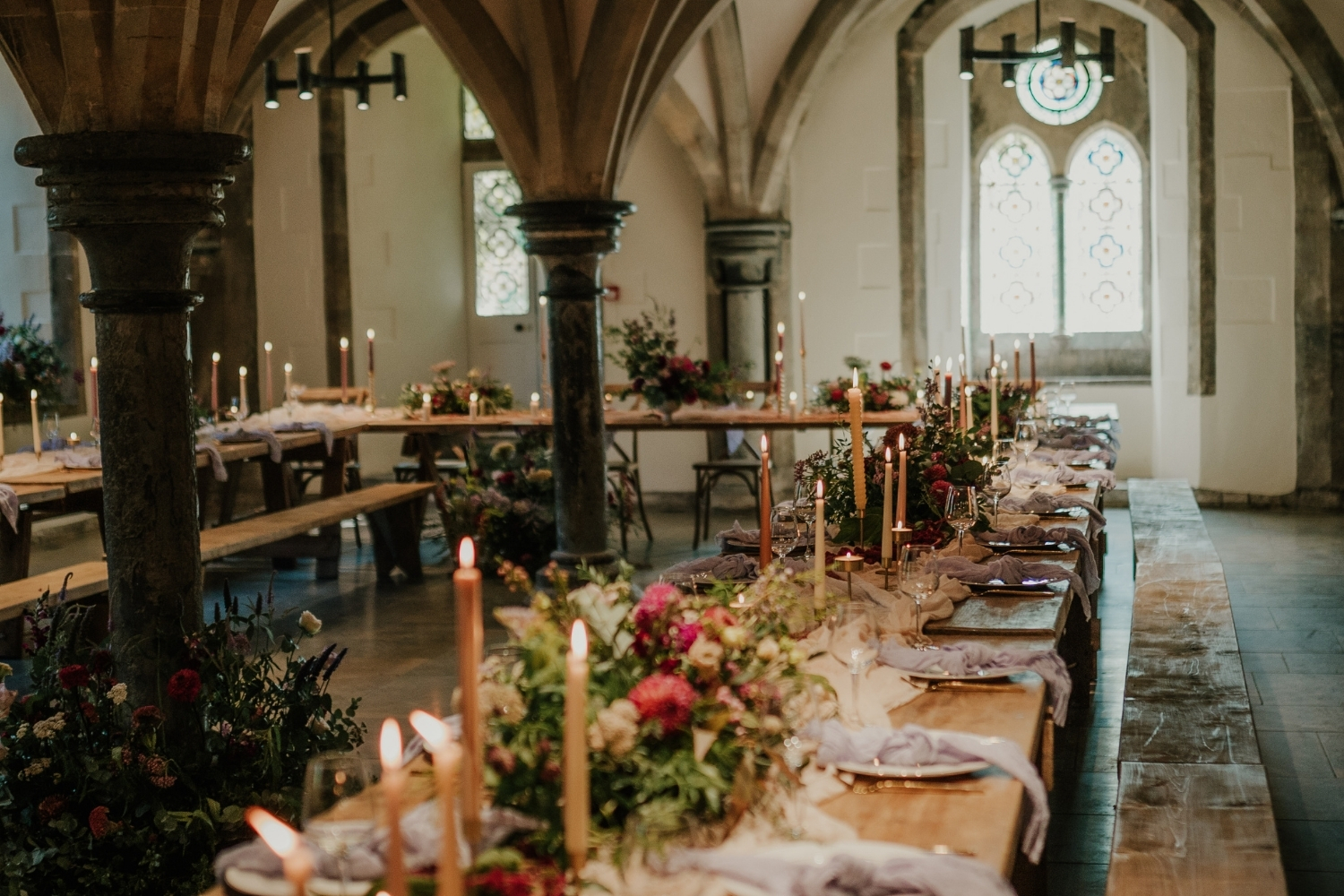 An image of the vaulted Undercroft decorated for a celebration dinner.