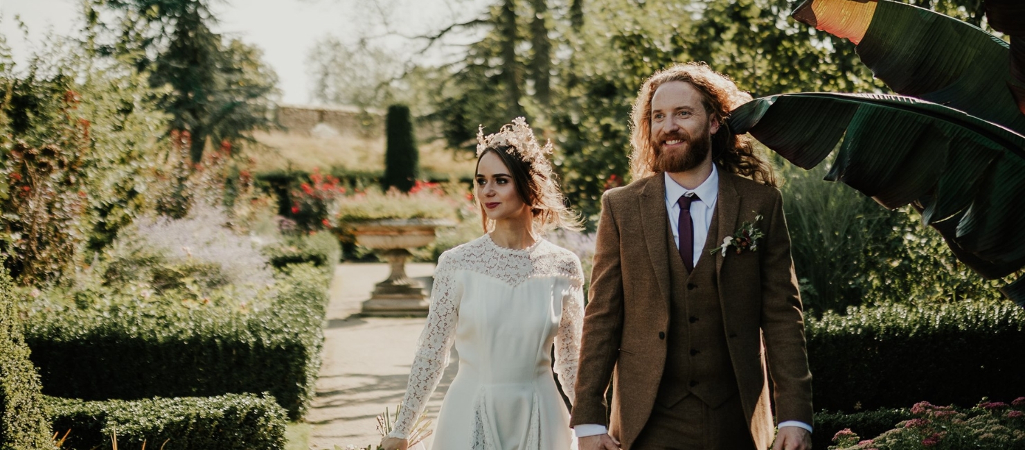 An image of a wedding couple at The Bishop's Palace in Wells for their wedding reception.